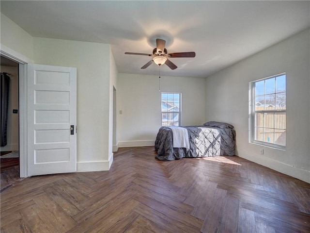 unfurnished bedroom featuring ceiling fan and parquet flooring