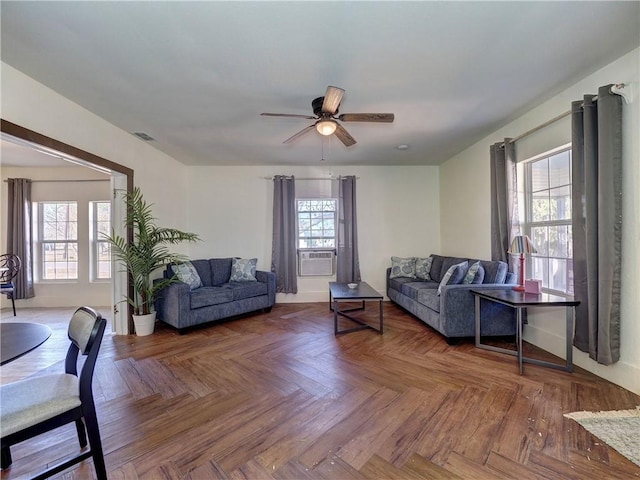 living room featuring parquet floors, cooling unit, and ceiling fan