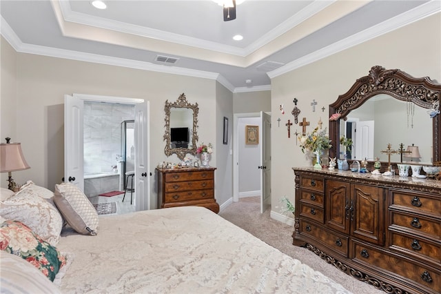 carpeted bedroom with ceiling fan, connected bathroom, a tray ceiling, and ornamental molding