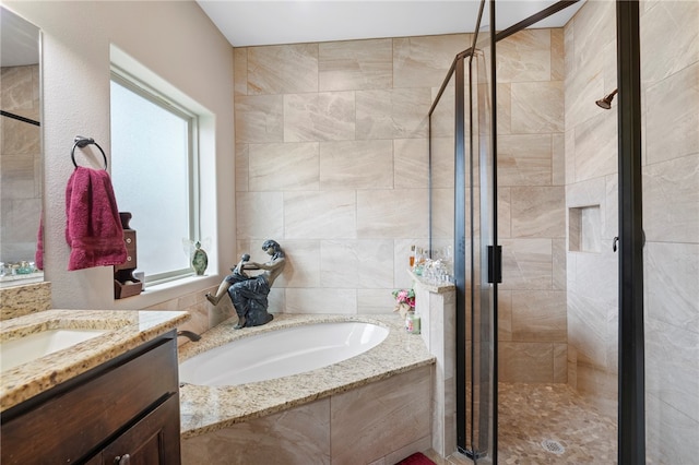 bathroom featuring independent shower and bath and vanity