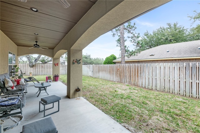 view of yard featuring ceiling fan and a patio