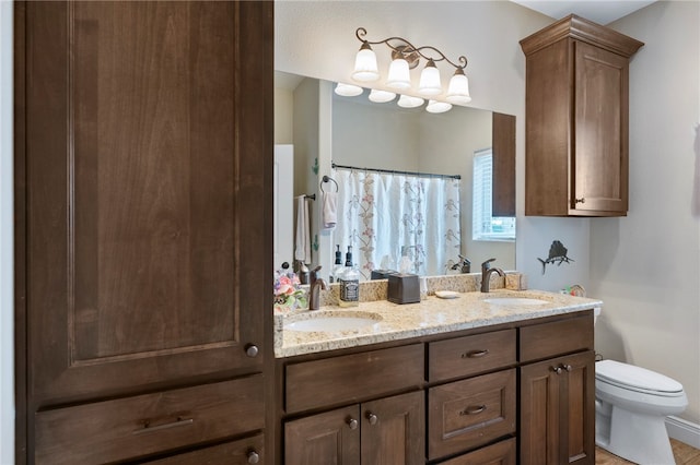 bathroom featuring toilet, vanity, and curtained shower