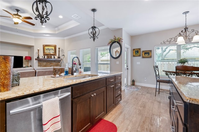 kitchen with dishwasher, sink, light hardwood / wood-style floors, and plenty of natural light