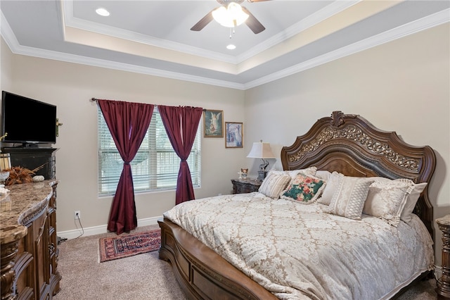 carpeted bedroom featuring a raised ceiling, ceiling fan, and crown molding