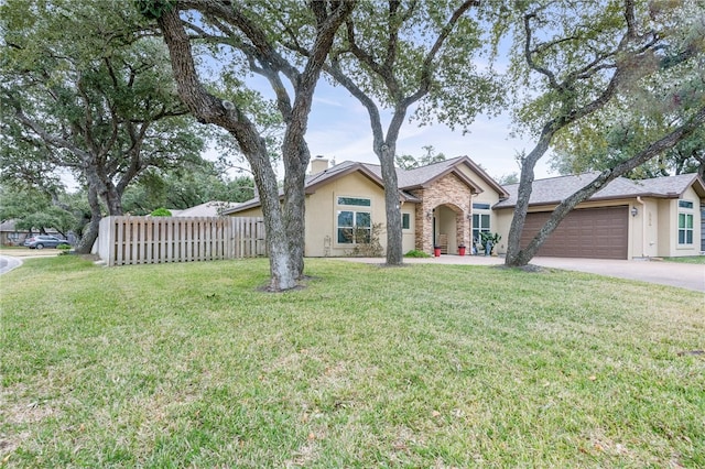 ranch-style house featuring a garage and a front yard