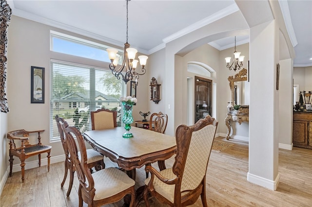 dining area featuring a wealth of natural light, an inviting chandelier, light hardwood / wood-style floors, and crown molding