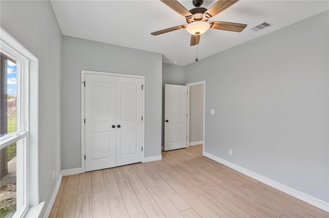 4338 Starlite, Corpus Christi, TX 78410 - unfurnished bedroom with a closet, visible vents, multiple windows, and light wood-style floors