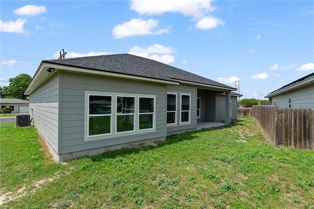 4338 Starlite, Corpus Christi, TX 78410 - rear view of property with a shingled roof, central air condition unit, a yard, and fence