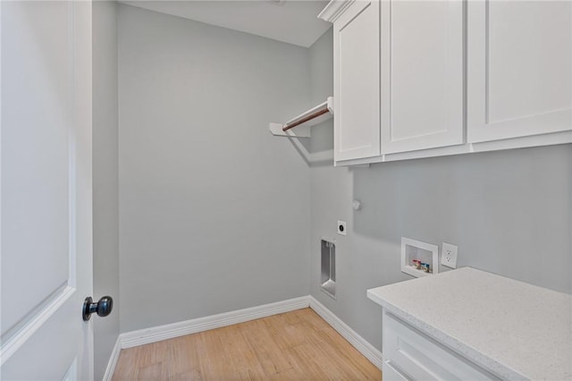 4338 Starlite, Corpus Christi, TX 78410 - washroom with baseboards, hookup for an electric dryer, light wood finished floors, and cabinet space