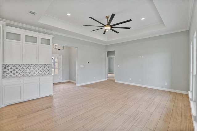 4338 Starlite, Corpus Christi, TX 78410 - unfurnished living room with baseboards, ceiling fan, a tray ceiling, and visible vents