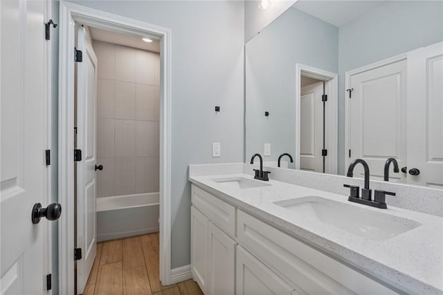 4338 Starlite, Corpus Christi, TX 78410 - full bath with double vanity, baseboards, a sink, and wood finished floors