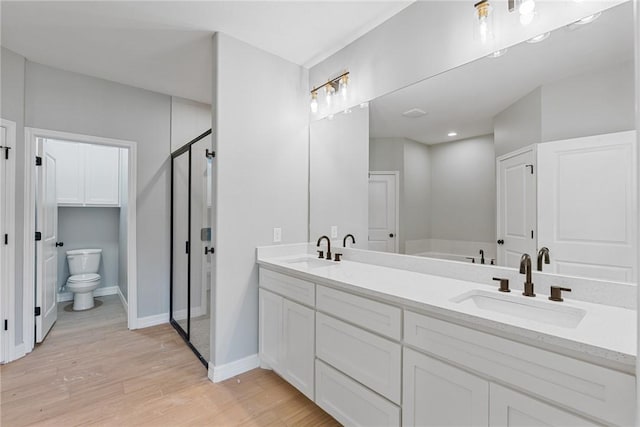 4338 Starlite, Corpus Christi, TX 78410 - full bath with wood finished floors, toilet, a sink, and a stall shower