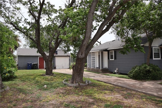 3119 Mcardle, Corpus Christi, TX 78415 - view of green lawn with concrete driveway and a garage