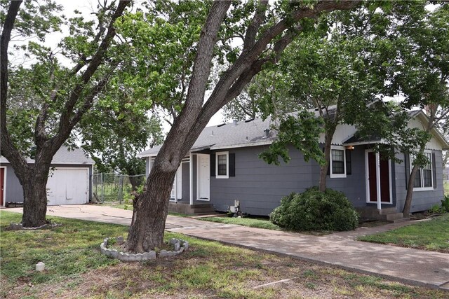 3119 Mcardle, Corpus Christi, TX 78415 - view of front of house with concrete driveway, entry steps, and a shingled roof