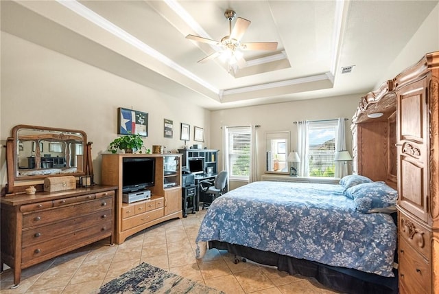 bedroom featuring light tile patterned floors, visible vents, a ceiling fan, a tray ceiling, and crown molding