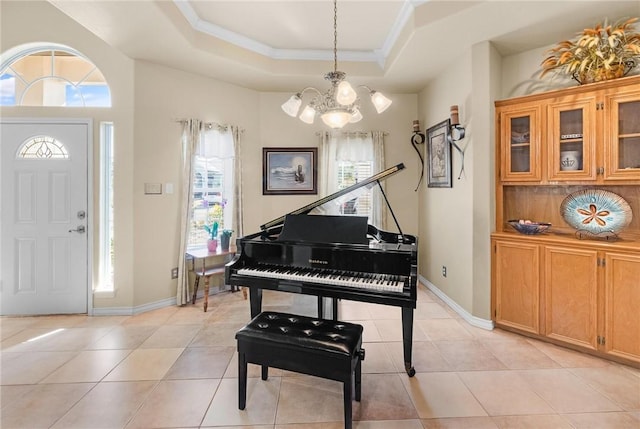 entrance foyer with a healthy amount of sunlight, a raised ceiling, and light tile patterned flooring