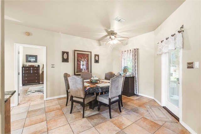 dining area with ceiling fan, visible vents, baseboards, and light tile patterned flooring