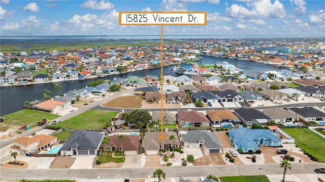 drone / aerial view featuring a residential view and a water view