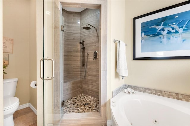 full bath with a stall shower, baseboards, toilet, a garden tub, and tile patterned flooring