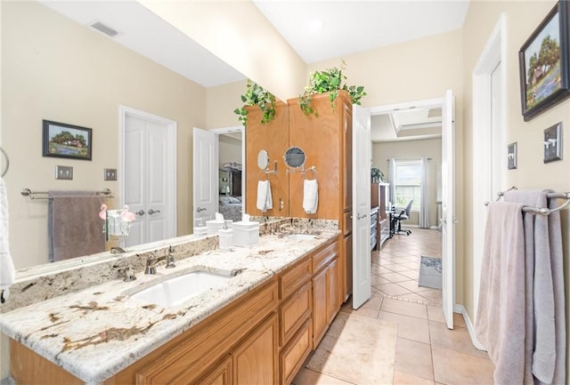 ensuite bathroom with double vanity, visible vents, ensuite bath, tile patterned flooring, and a sink