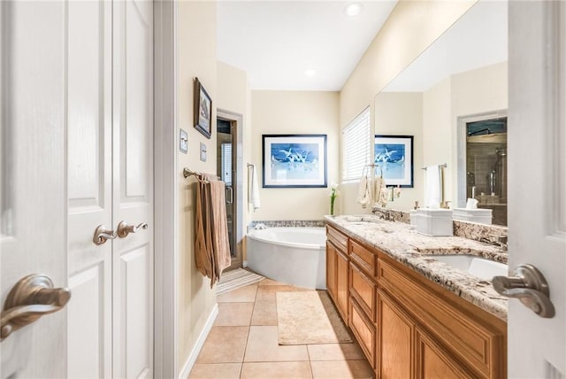 bathroom with a sink, tile patterned flooring, double vanity, and a closet