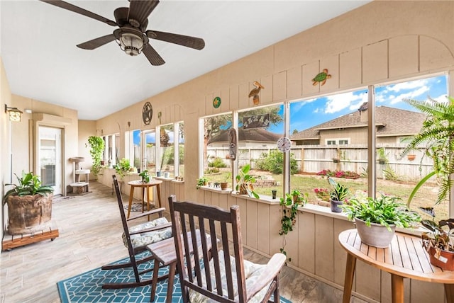 sunroom / solarium with a ceiling fan and a wealth of natural light