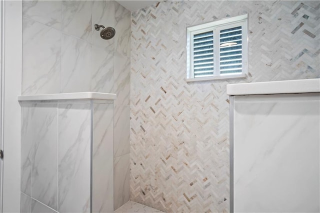 bathroom featuring a marble finish shower