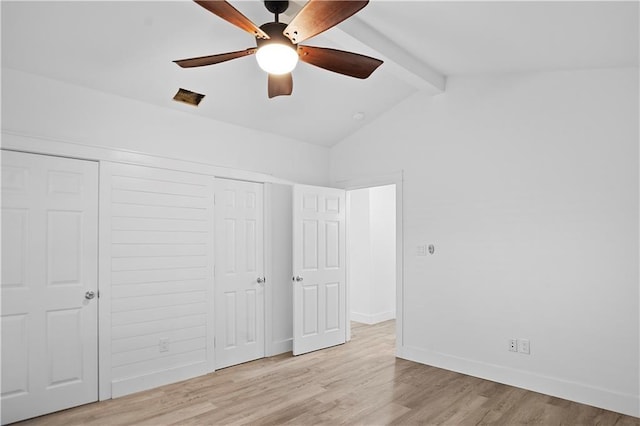 unfurnished bedroom with lofted ceiling with beams, ceiling fan, wood finished floors, baseboards, and a closet