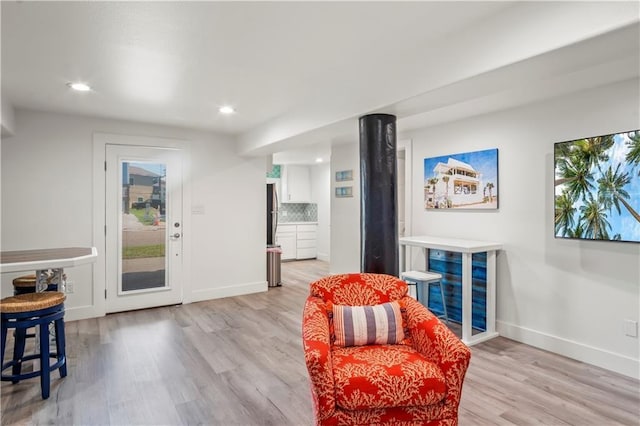 living area featuring light wood finished floors, recessed lighting, and baseboards