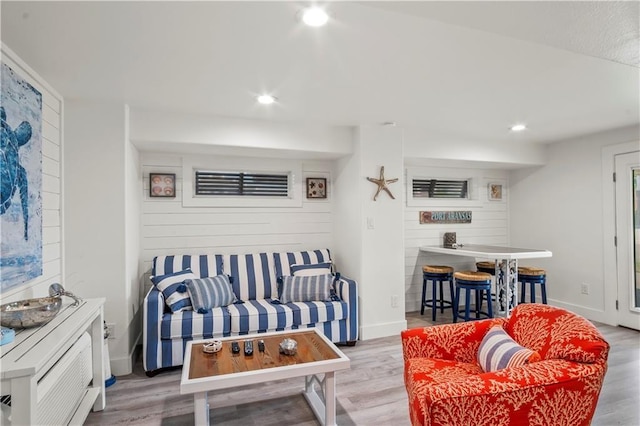 living area featuring recessed lighting, baseboards, and wood finished floors