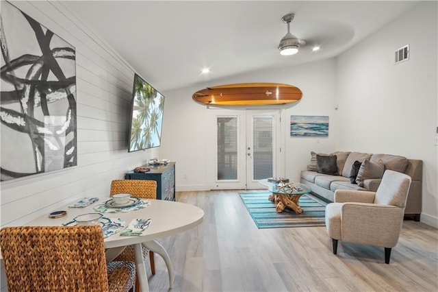 living room featuring visible vents, a ceiling fan, wood finished floors, vaulted ceiling, and french doors