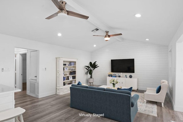 living area with recessed lighting, visible vents, lofted ceiling with beams, wood finished floors, and baseboards