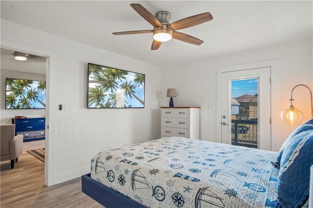 bedroom with access to outside, wood finished floors, a ceiling fan, and baseboards