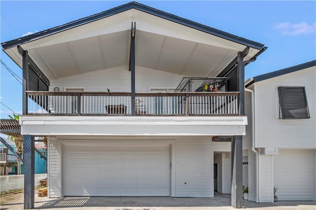 view of front of property featuring a balcony and an attached garage