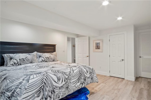 bedroom featuring recessed lighting, light wood-style flooring, and baseboards