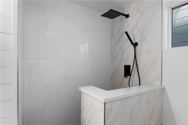 bathroom featuring a walk in shower and tile walls