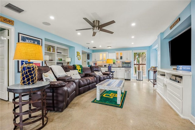 living room featuring ceiling fan, visible vents, built in features, and recessed lighting