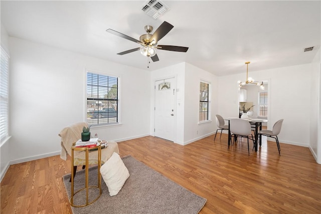 interior space featuring visible vents, light wood-style flooring, and baseboards