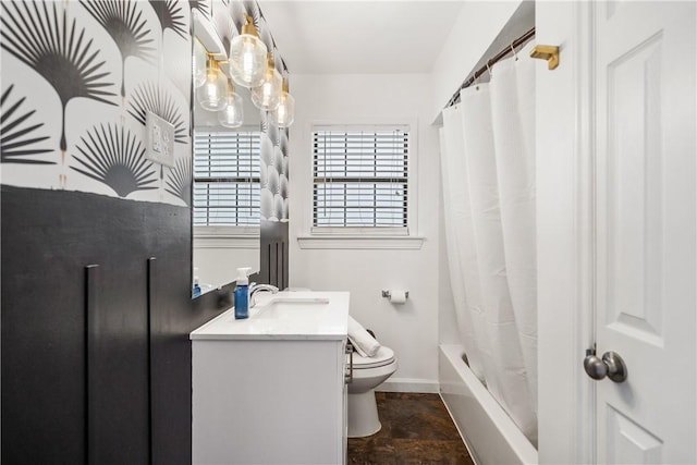 full bathroom with shower / tub combo, baseboards, vanity, and toilet