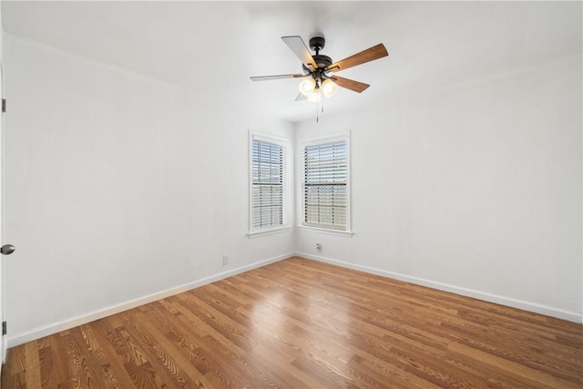 spare room with a ceiling fan, baseboards, and wood finished floors