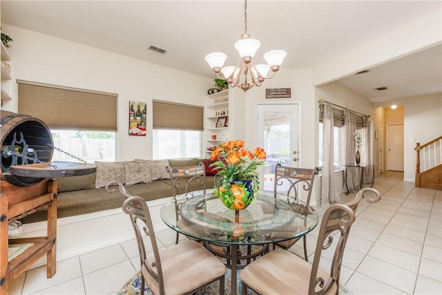 2522 Fleece Dr, Corpus Christi, TX 78414 - dining room featuring a chandelier, light tile patterned floors, and stairway