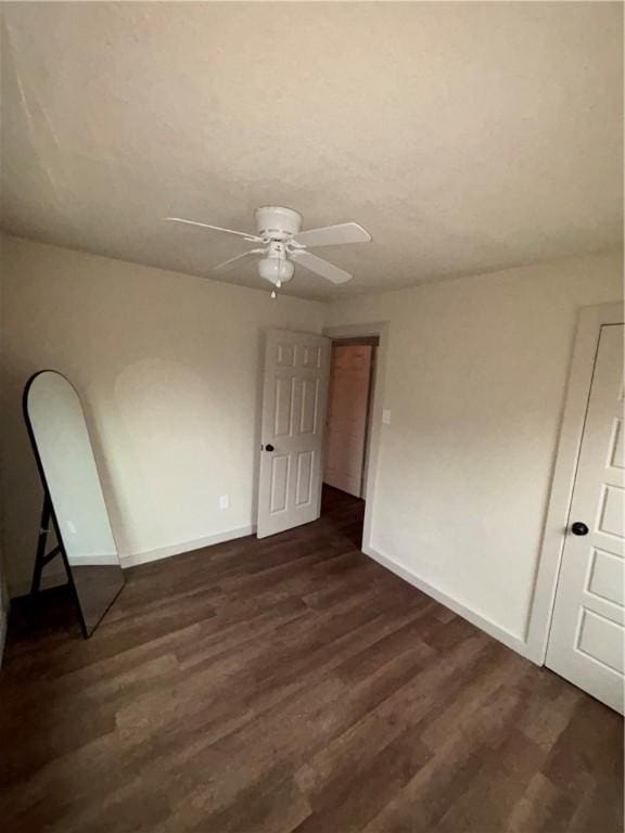 unfurnished room featuring dark hardwood / wood-style floors and ceiling fan