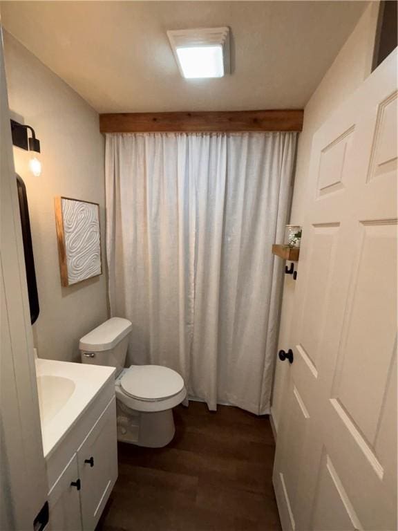 bathroom with vanity, wood-type flooring, and toilet