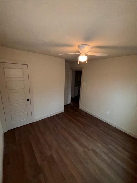 spare room featuring dark hardwood / wood-style floors and ceiling fan