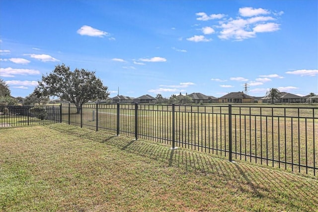 view of yard with a residential view and fence