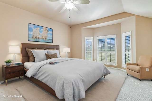 bedroom featuring lofted ceiling, ceiling fan, and baseboards