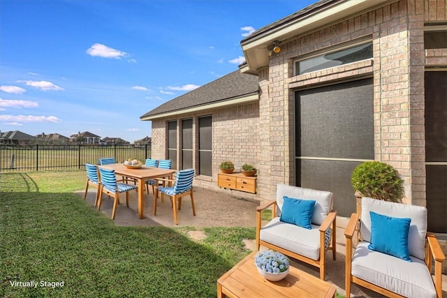 view of patio featuring fence and an outdoor hangout area