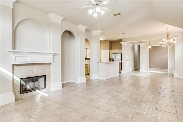 unfurnished living room featuring a tile fireplace, visible vents, ceiling fan, and light tile patterned flooring