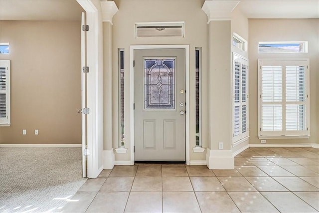 foyer entrance featuring light tile patterned floors and baseboards