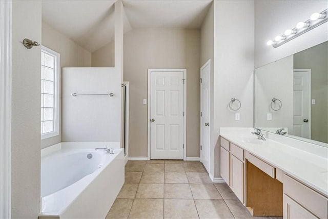 full bathroom with double vanity, tile patterned floors, a garden tub, vaulted ceiling, and a sink